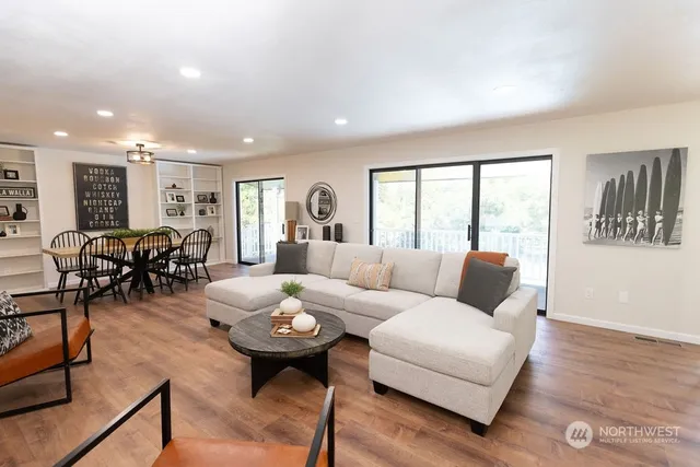 a living room with furniture and wooden floor