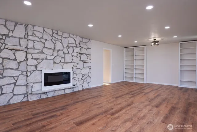 a living room with a fireplace and a flat screen tv