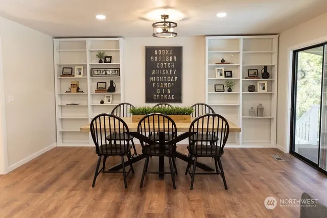 a view of a dining room with furniture window and wooden floor