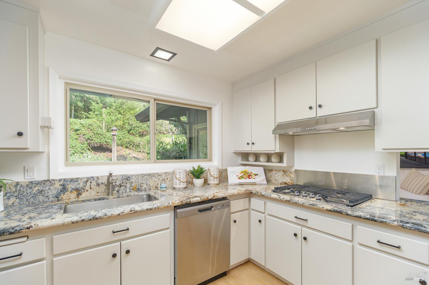 9 Underhill Road Mill Valley, CA 94941 - Photo 11 of 27 a kitchen with granite countertop white cabinets and a window