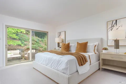 a bedroom with a bed and a large window with outer view