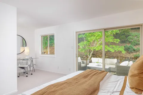 a bedroom with a large bed and a lamp next to a window