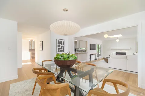 a kitchen with granite countertop a stove a sink and a refrigerator
