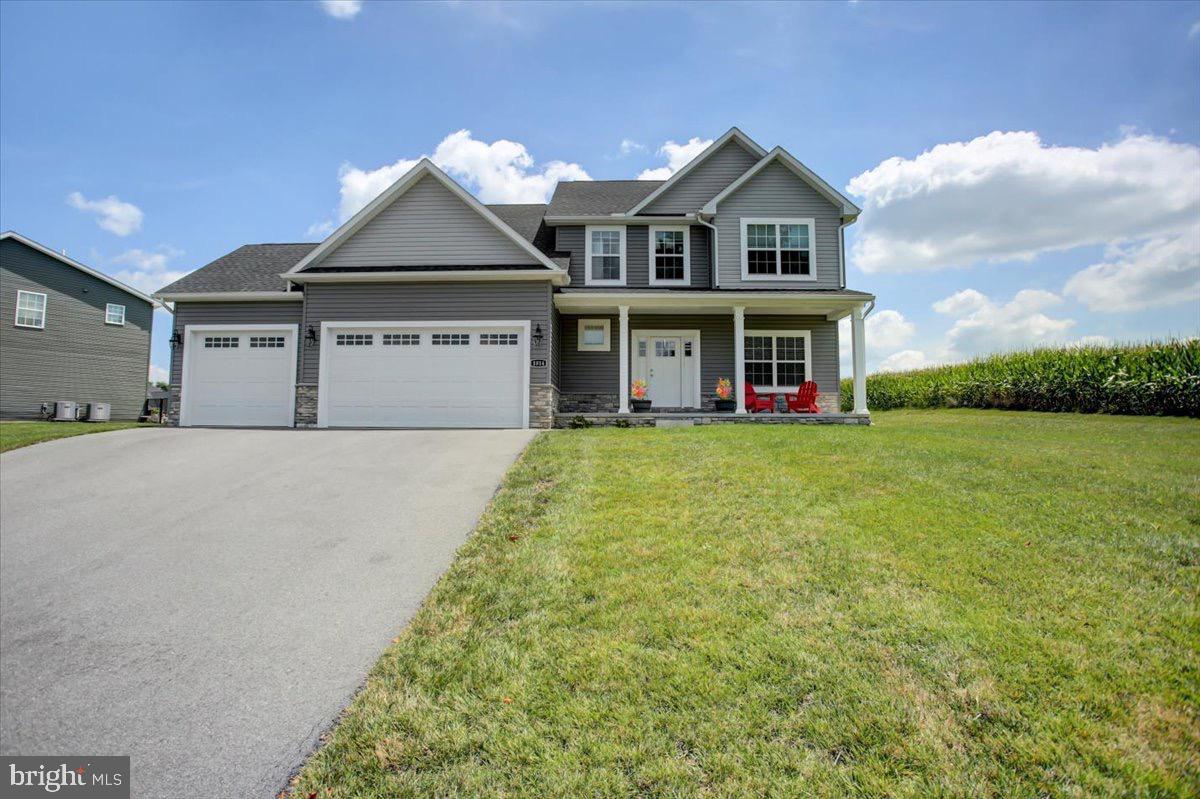 1014 Divinity Drive Greencastle, PA 17225 - Photo 1 of 56 a front view of a house with a yard and garage