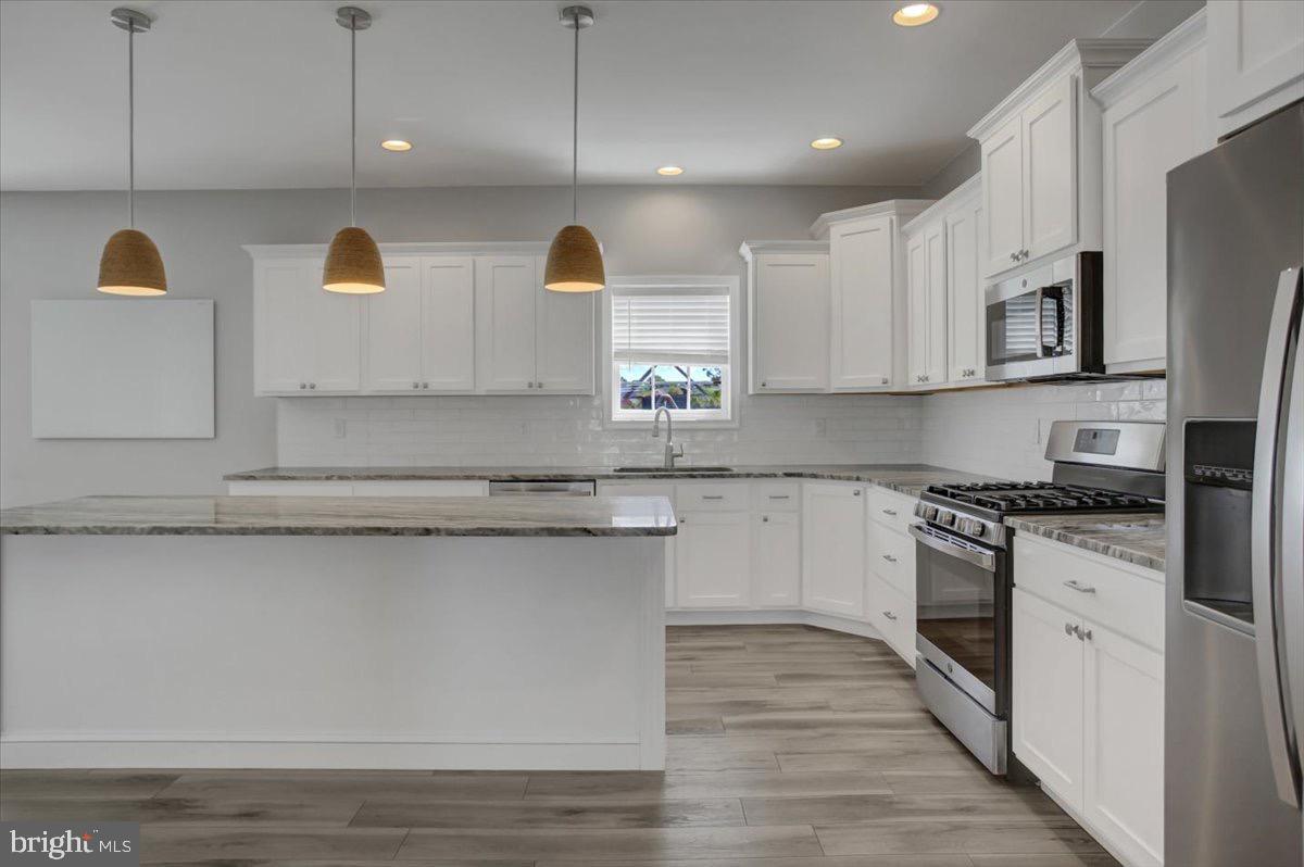 1014 Divinity Drive Greencastle, PA 17225 - Photo 11 of 56 a kitchen with stainless steel appliances granite countertop a stove a sink and a microwave