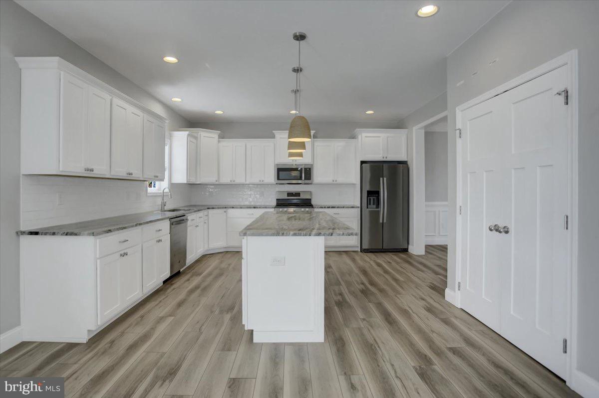 1014 Divinity Drive Greencastle, PA 17225 - Photo 12 of 56 a large kitchen with stainless steel appliances granite countertop a lot of counter space and wooden floors