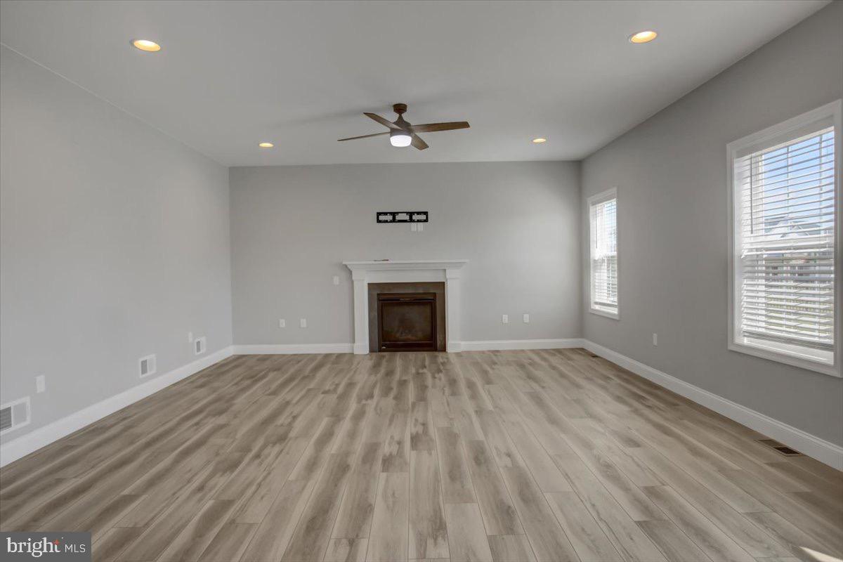 1014 Divinity Drive Greencastle, PA 17225 - Photo 18 of 56 an empty room with windows and a fireplace