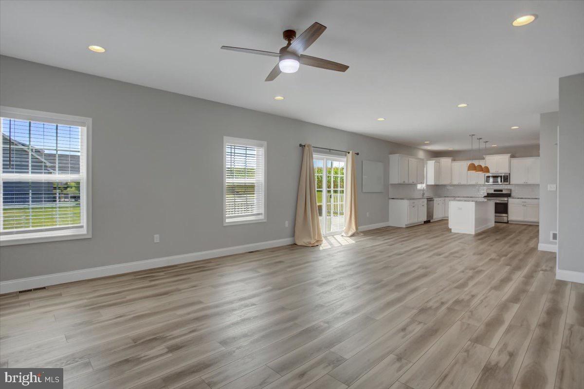 1014 Divinity Drive Greencastle, PA 17225 - Photo 19 of 56 a view of an empty room with window and wooden floor