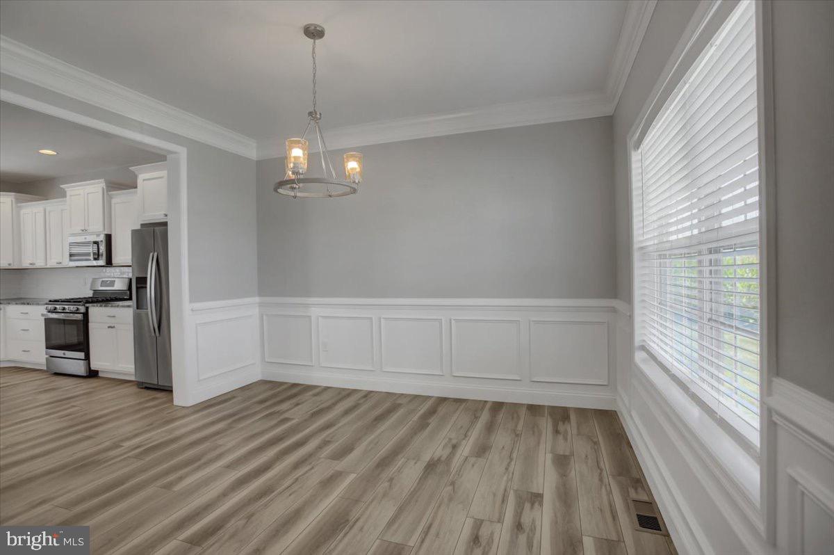 1014 Divinity Drive Greencastle, PA 17225 - Photo 8 of 56 a view of a kitchen with wooden floor and a window