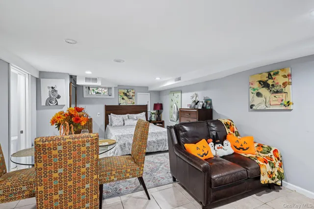 a dining room with furniture and a mirror