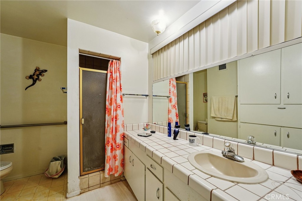 18947 Waseca Road Apple Valley, CA 92307 - Photo 14 of 34 a bathroom with a sink and a mirror