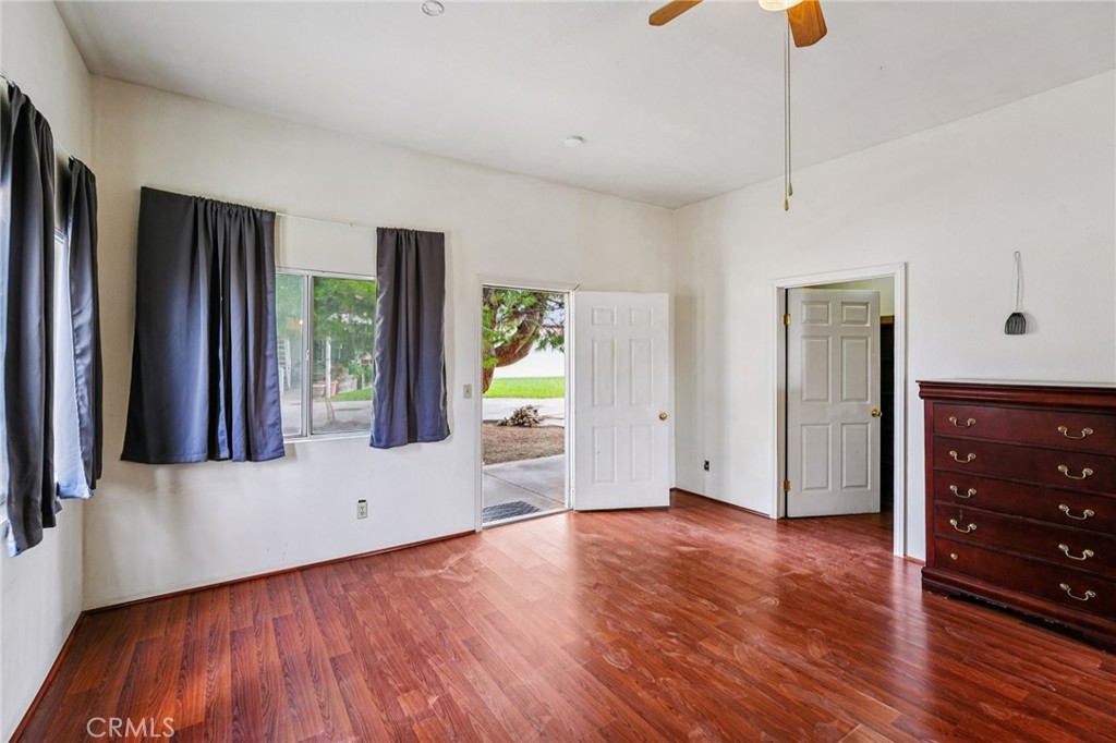 18947 Waseca Road Apple Valley, CA 92307 - Photo 18 of 34 a view of an empty room with wooden floor and a window