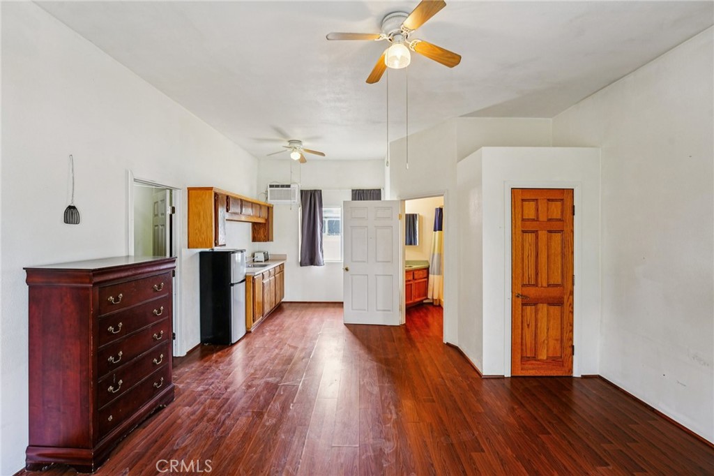 18947 Waseca Road Apple Valley, CA 92307 - Photo 19 of 34 a view of a kitchen with a sink cabinet a refrigerator and wooden floor