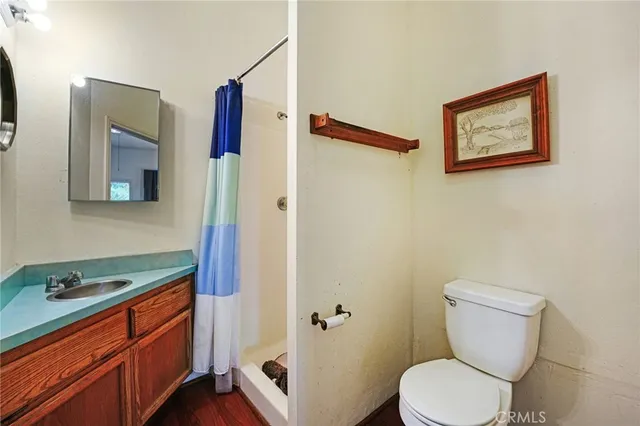 a bathroom with a toilet a sink and shower