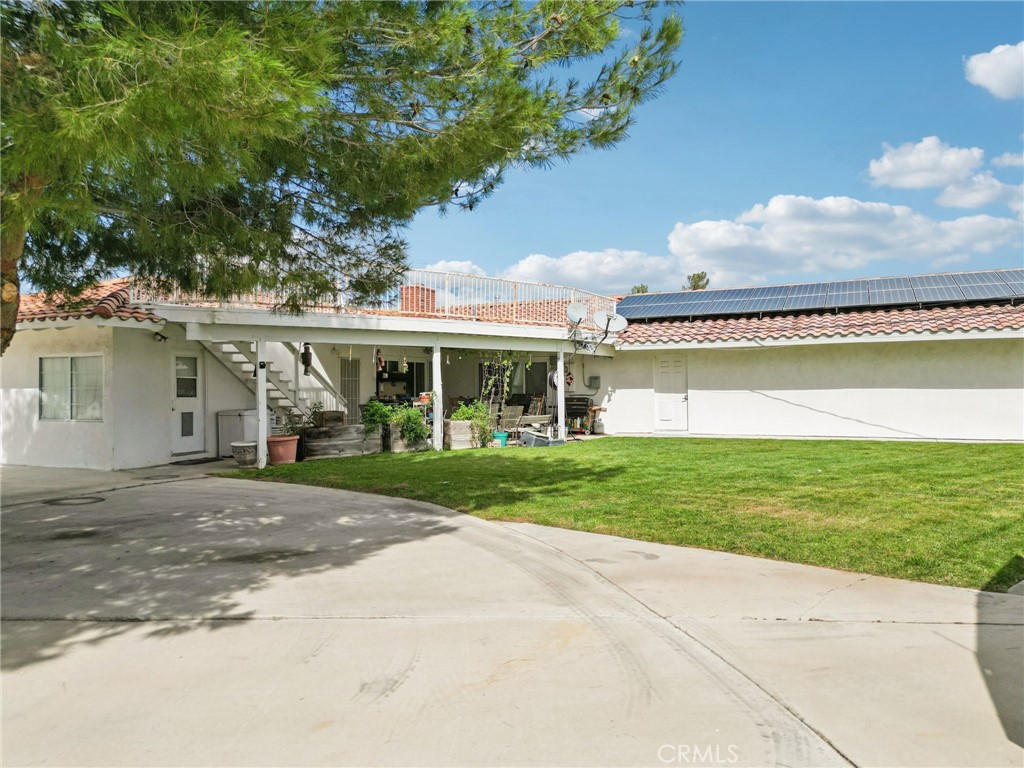 18947 Waseca Road Apple Valley, CA 92307 - Photo 22 of 34 a front view of a house with a garden and yard