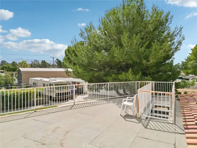 a view of balcony with wooden fence