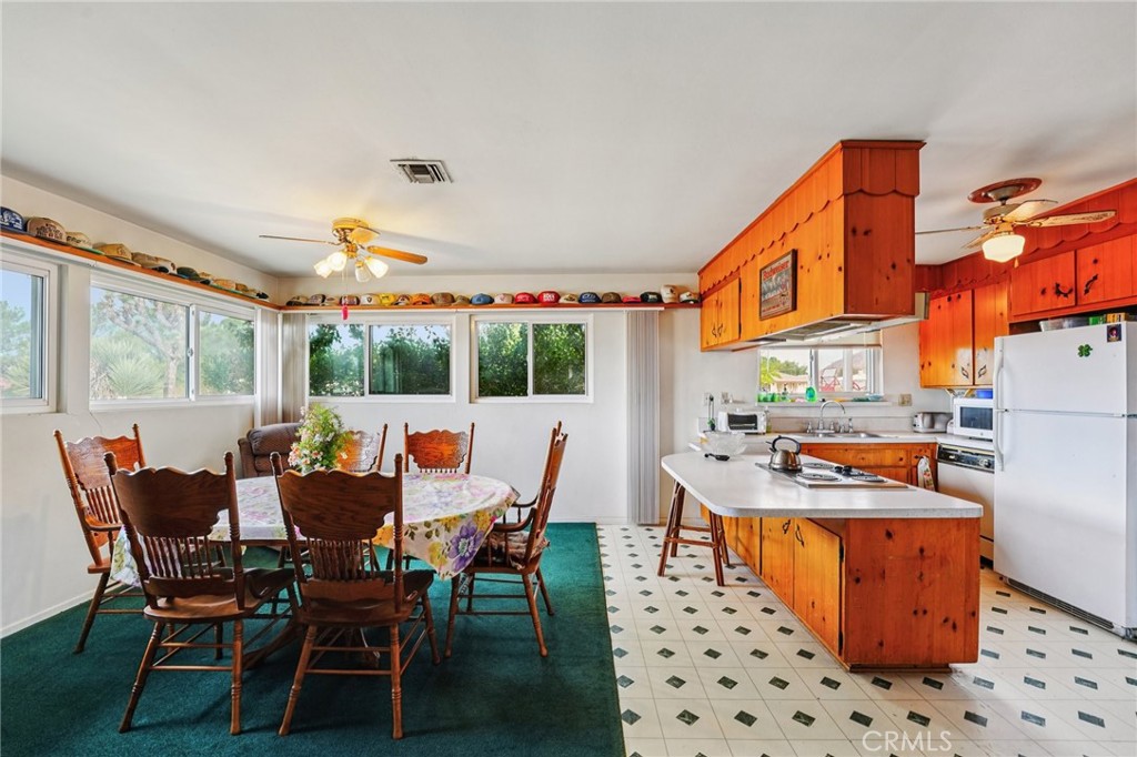 18947 Waseca Road Apple Valley, CA 92307 - Photo 5 of 34 a dining room with a table and chairs