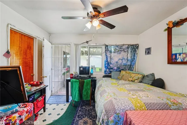 a bedroom with a bed dresser and a window