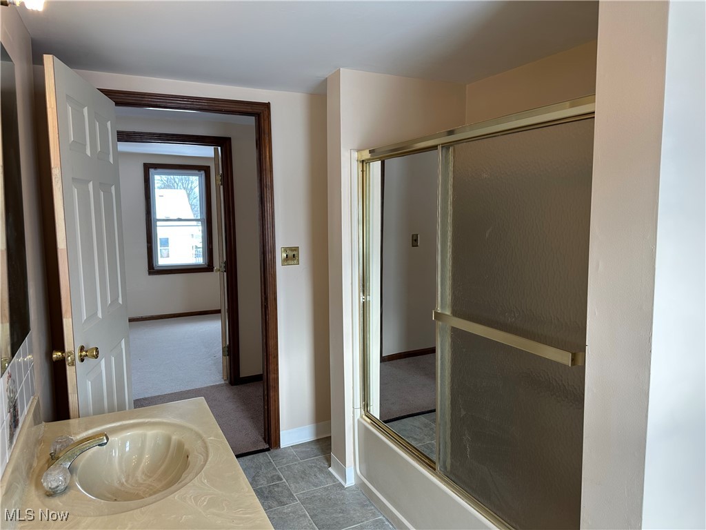 60 Taylor Road Barberton, OH 44203 - Photo 21 of 35 Second floor Bathroom with vanity and bath / shower combo with glass door
