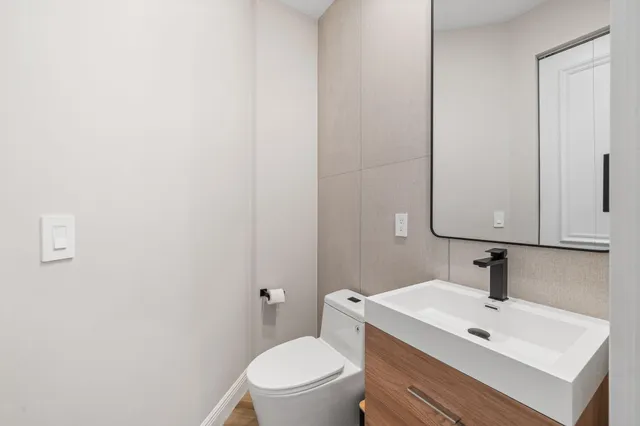 a bathroom with a sink a toilet and mirror