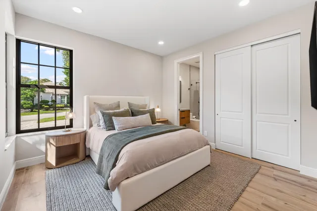 a bedroom with a large bed and a large window