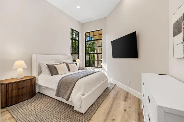 a bedroom with a bed and a flat screen tv