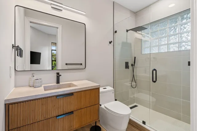 a bathroom with a sink toilet and shower