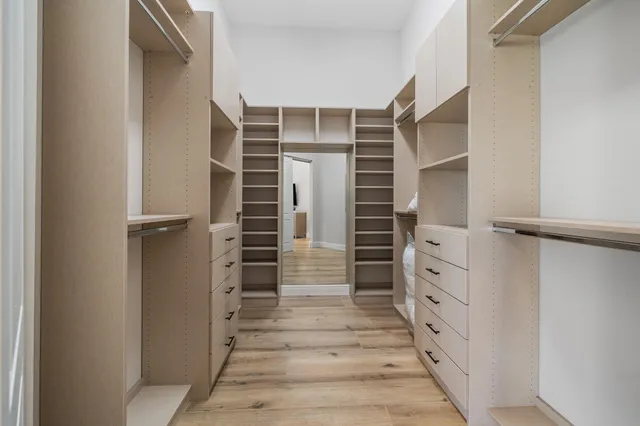 a view of walk in closet with empty racks