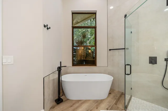 a bathroom with a tub and shower