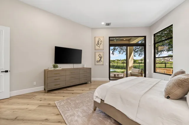 a bedroom with a flat screen tv and a bed