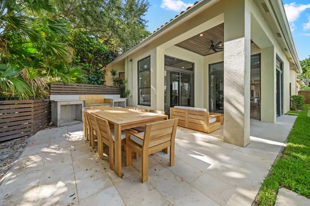 a view of a patio with table and chairs and potted plants