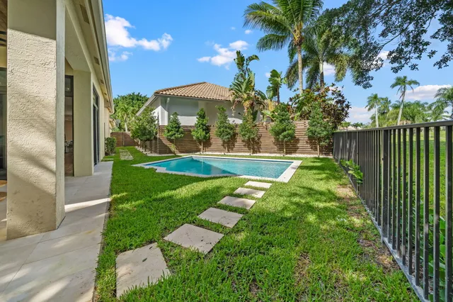 a view of a house with a yard and potted plants