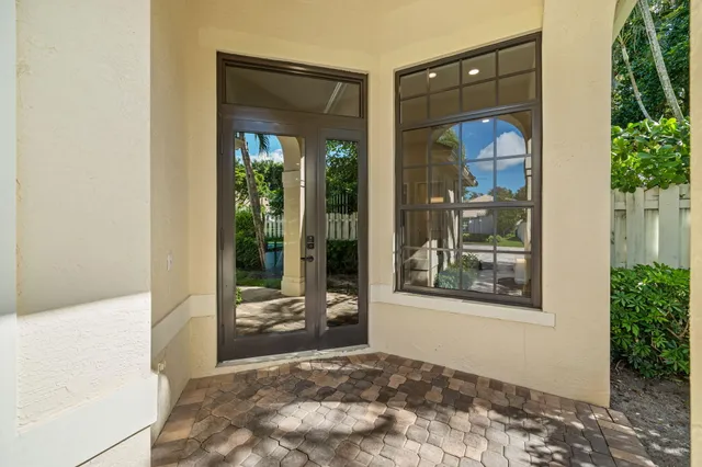 a view of a bedroom with a bed and glass door