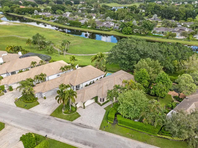 an aerial view of residential houses with outdoor space and river