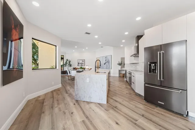 a view of kitchen with refrigerator microwave and wooden floor