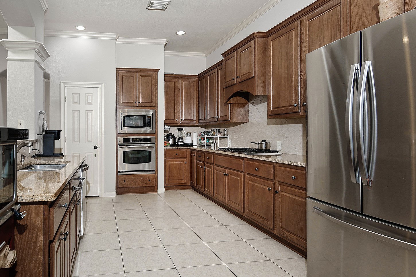 18722 Duke Lake Drive Spring, TX 77388 - Photo 9 of 26 a kitchen with stainless steel appliances granite countertop a refrigerator stove and sink