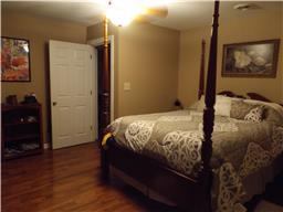 2156 River Road Clarksville, TN 37040 - Photo 9 of 17 a bed sitting in a bedroom next to a bathroom