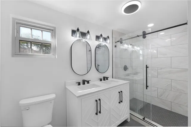 a kitchen with a sink a stove top oven and cabinetry