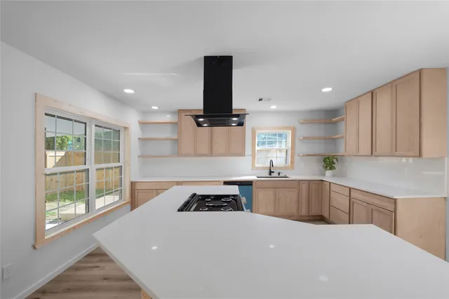 a kitchen with a stove a sink and a refrigerator