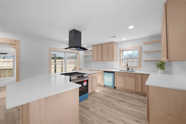 a kitchen with stainless steel appliances granite countertop a sink stove and cabinets