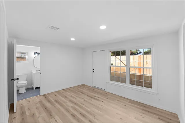 a bedroom with a large bed and a window