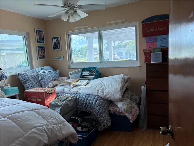 a work room with lots of furniture and a flat screen tv