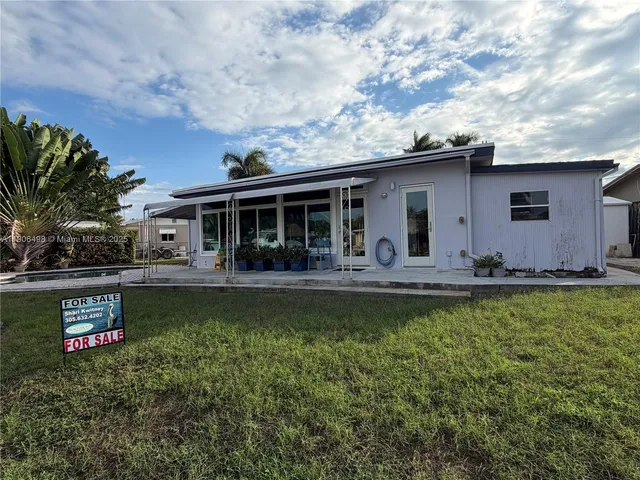 a view of a house with backyard porch and sitting area