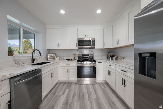 476 Spring Drive Toquerville, UT 84774 - Photo 72 of 95 Kitchen featuring stainless steel appliances, white cabinetry, light stone counters, light wood finished floors, and recessed lighting