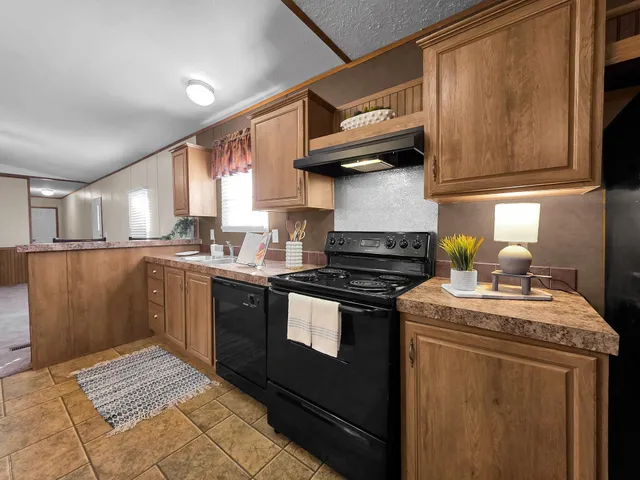 a kitchen with stainless steel appliances granite countertop a sink counter space and a table
