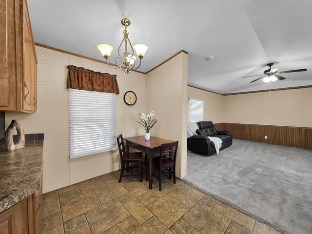 a kitchen with granite countertop a sink a stove and cabinets