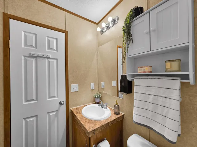 a bathroom with a sink toilet a mirror and shower