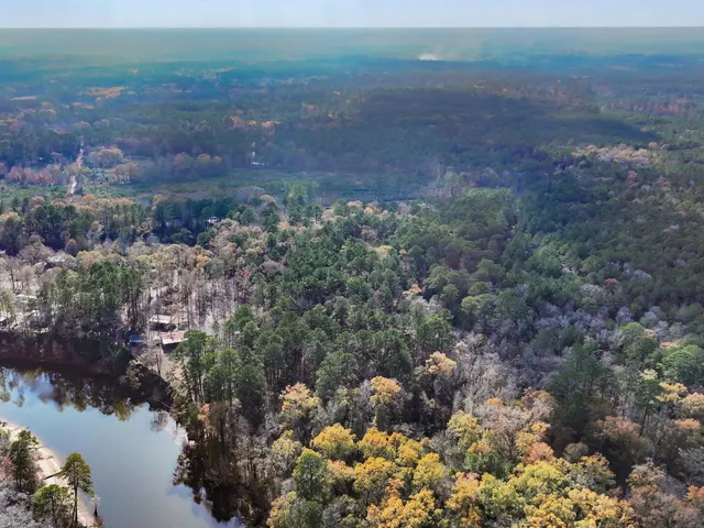 a view of a swimming pool with a patio and a yard