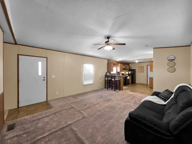 a living room with furniture and a dining table with projector