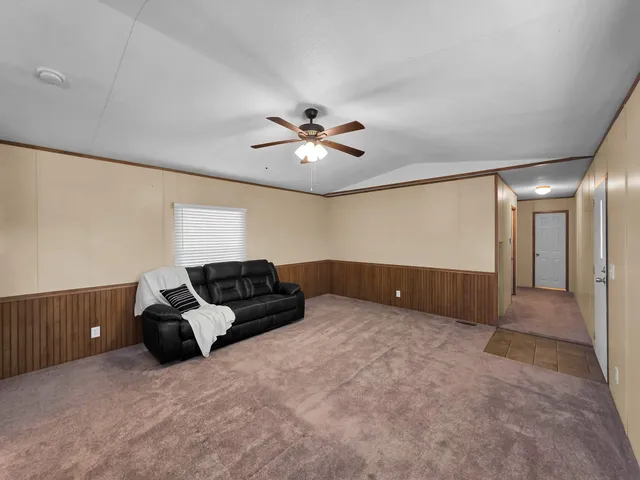 a kitchen with granite countertop a stove a sink and a refrigerator